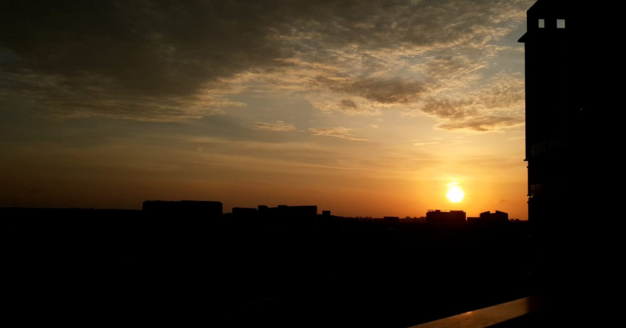 Sunrise over a horizon from the balcony of a building