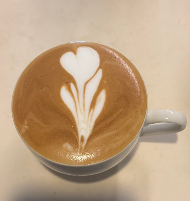 A cup of latte with a tulip latte art design